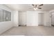 Bright living room with neutral carpet, a ceiling fan, and a large window for natural light at 30169 N Sunray Dr, San Tan Valley, AZ 85143