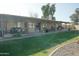 Covered patio and backyard with well maintained landscaping at 3119 S Stewart Cir, Mesa, AZ 85202