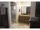 Bathroom featuring a granite countertop vanity, framed mirror, and a glass-enclosed shower at 3119 S Stewart Cir, Mesa, AZ 85202