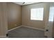 This bedroom features neutral walls, carpet flooring, and a window providing natural light at 3119 S Stewart Cir, Mesa, AZ 85202