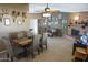 This dining area features a wood table with seating for six, adjacent to a charming brick fireplace at 3119 S Stewart Cir, Mesa, AZ 85202