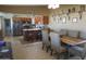 Dining area leading to a kitchen with a center island, stainless steel appliances, and custom shelving at 3119 S Stewart Cir, Mesa, AZ 85202