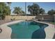 View of backyard pool surrounded by desert landscaping and secure fencing at 3119 S Stewart Cir, Mesa, AZ 85202