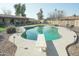 Inviting backyard pool with diving board, patio, and lush landscaping at 3119 S Stewart Cir, Mesa, AZ 85202