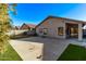 Rear exterior of home featuring an expansive backyard with a concrete patio and artificial turf at 3232 E Hononegh Dr, Phoenix, AZ 85050