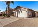 Charming single-story home featuring a two-car garage and desert landscaping at 3232 E Hononegh Dr, Phoenix, AZ 85050