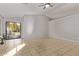 Bright and airy living room with tile flooring and sliding glass doors to the backyard at 3232 E Hononegh Dr, Phoenix, AZ 85050