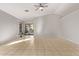 Bright and airy living room with tile flooring and sliding glass doors to the backyard at 3232 E Hononegh Dr, Phoenix, AZ 85050