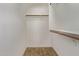 Empty closet shows laminate flooring and wooden clothing racks at 3232 E Hononegh Dr, Phoenix, AZ 85050