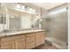 Primary bathroom with double sinks, granite counters, and a glass shower door at 3365 W Abraham Ln, Phoenix, AZ 85027