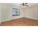 Bright bedroom featuring wood-look floors and a ceiling fan with light fixture at 3365 W Abraham Ln, Phoenix, AZ 85027