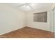 Comfortable bedroom with laminate flooring, a ceiling fan, and a window with blinds at 3365 W Abraham Ln, Phoenix, AZ 85027