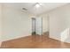 Bright bedroom with laminate wood flooring, and closet with mirrored doors at 3365 W Abraham Ln, Phoenix, AZ 85027