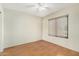 Cozy bedroom with laminate flooring, a ceiling fan, and a window at 3365 W Abraham Ln, Phoenix, AZ 85027