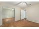 Neutral bedroom features wood floors, mirrored closet doors and a ceiling fan at 3365 W Abraham Ln, Phoenix, AZ 85027