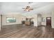 Open-concept living space with wood-look tile floors connecting to the kitchen area at 3365 W Abraham Ln, Phoenix, AZ 85027