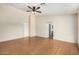 Inviting living room with wood laminate flooring, a ceiling fan, and natural light from the window at 3365 W Abraham Ln, Phoenix, AZ 85027