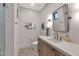 Stylish powder bathroom with designer mirror, modern vanity and hexagon tiled floor at 3511 E Orange Dr, Phoenix, AZ 85018