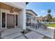 Inviting front patio with stylish furniture, brick accents, and a unique front door at 3511 E Orange Dr, Phoenix, AZ 85018