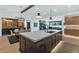 Open-concept kitchen and dining area featuring an oversized kitchen island and modern light fixtures at 3511 E Orange Dr, Phoenix, AZ 85018