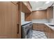 Well-organized laundry room featuring modern appliances, ample cabinetry and counter space at 3511 E Orange Dr, Phoenix, AZ 85018