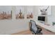 Dedicated office space with built-in desk, sleek chair, and desert themed artwork at 3511 E Orange Dr, Phoenix, AZ 85018