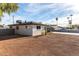 View of the backyard with its red gravel and white painted brick home at 3637 E Yale St, Phoenix, AZ 85008