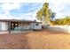 Exterior view of a backyard with covered patio and manicured desert landscape at 3637 E Yale St, Phoenix, AZ 85008