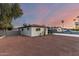 View of the backyard with its red gravel and white painted brick home at 3637 E Yale St, Phoenix, AZ 85008