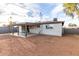 Home's backyard featuring covered patio, manicured desert landscape and fencing at 3637 E Yale St, Phoenix, AZ 85008