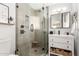 Modern bathroom featuring a glass-enclosed shower and vanity with storage at 3637 E Yale St, Phoenix, AZ 85008