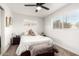 Cozy bedroom with a comfortable bed, ceiling fan, and natural light from a large window at 3637 E Yale St, Phoenix, AZ 85008