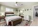 Bright bedroom with a ceiling fan, neutral rug, stylish decor, and a mirrored closet at 3637 E Yale St, Phoenix, AZ 85008