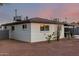 View of the back of the home with a light colored brick and a brown roof at 3637 E Yale St, Phoenix, AZ 85008