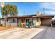 Charming front of home featuring a grey exterior, large driveway, and colorful door at 3637 E Yale St, Phoenix, AZ 85008