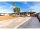 Charming exterior features a gray house with large driveway, colorful entrance and mature landscaping at 3637 E Yale St, Phoenix, AZ 85008