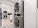 Efficient laundry area featuring a modern stackable washer and dryer and views into the kitchen at 3637 E Yale St, Phoenix, AZ 85008