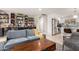 Living room with couch, bright lighting, shelving and open layout to a modern kitchen at 3637 E Yale St, Phoenix, AZ 85008