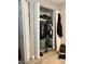 Open closet with folding doors filled with shoes and clothes; the floor is hardwood at 3645 N 69Th Ave # 67, Phoenix, AZ 85033