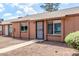 Modest one-story home with a light brown exterior, a black security door, and a well-maintained front yard at 3645 N 69Th Ave # 67, Phoenix, AZ 85033