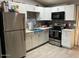 Modern kitchen boasts stainless steel appliances, sleek countertops, tiled backsplash, and ample cabinet space at 3645 N 69Th Ave # 67, Phoenix, AZ 85033