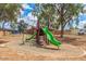 Community playground with modern play structure and mature trees at 3645 N 69Th Ave # 67, Phoenix, AZ 85033