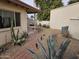 Backyard featuring desert landscaping, gravel, brick pathway, and patio area at 3706 S Dennis Dr, Tempe, AZ 85282