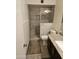 Modern bathroom with a tiled shower stall and granite countertop vanity at 3706 S Dennis Dr, Tempe, AZ 85282