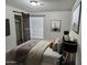 Cozy bedroom featuring a sliding barn door and comfortable neutral bedding at 3706 S Dennis Dr, Tempe, AZ 85282