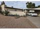 Single-story home with mature desert landscaping and a covered parking area at 3706 S Dennis Dr, Tempe, AZ 85282