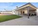 Home's covered patio transitions to artificial turf yard and a seating area at 3803 S Elm St, Tempe, AZ 85282