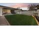 Spacious backyard with artificial turf, gravel and covered patio at 3803 S Elm St, Tempe, AZ 85282