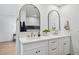 Bright bathroom featuring double sinks, gold fixtures, and stylish arched mirrors at 3803 S Elm St, Tempe, AZ 85282