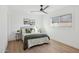 Bright bedroom with a queen bed, a modern ceiling fan, and minimalist decorations at 3803 S Elm St, Tempe, AZ 85282